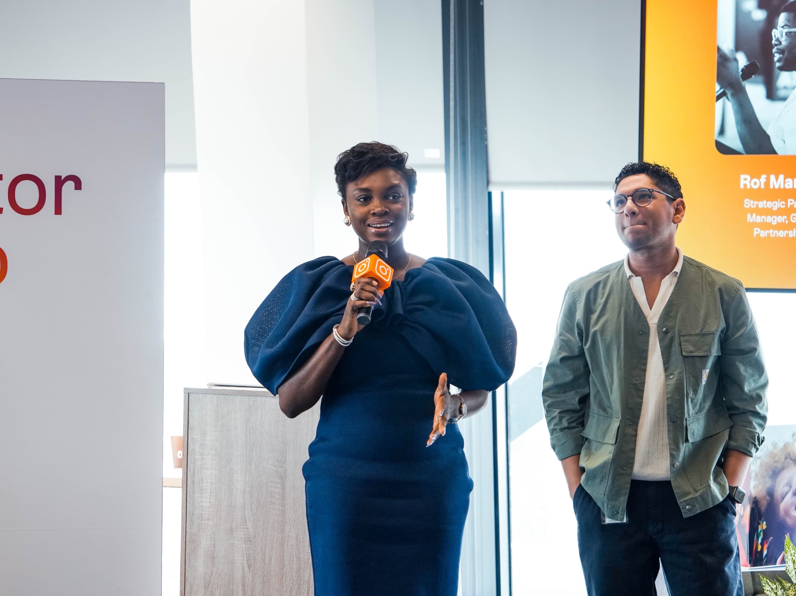 Woman speaking into a microphone at a Bloom conversation